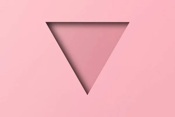 ピンクの紙切り穴光と影で三角形の形が重ねられています — ストック写真