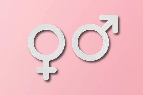 白纸切割成男性和女性的符号形状 设置在粉红色背景上 — 图库照片