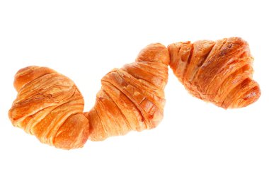 Arka planda taze kruvasanlar var.