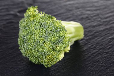 Broccoli isolated isolation on the black SLATE