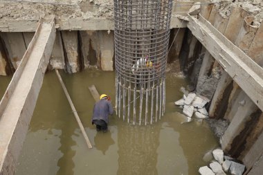 Çelik köprü inşaatı mühendisliğinde kaynak işçileri iş başında.