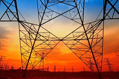 Electric tower, silhouette at sunset clipart