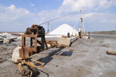 Old mechanical equipment in the salt field clipart