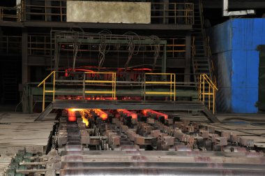 Hot steel in the steel mill workshop production line  clipart