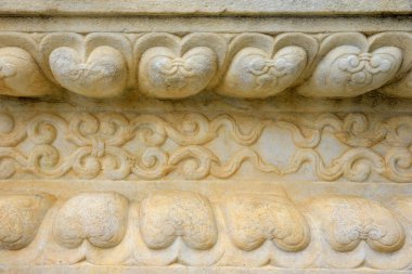 Taşın üzerindeki eski bir süs. Yakın plan dikişsiz doku. Taş dokusu. Taştaki desen. Kabartmalı desen