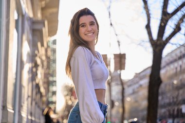 Genç, güzel, gülümseyen hippi kadın portresi. Günbatımında sokakta poz veren kaygısız seksi manken. Açık havada pozitif model.