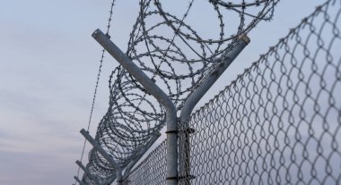 Fence with barbed wire, restricted area