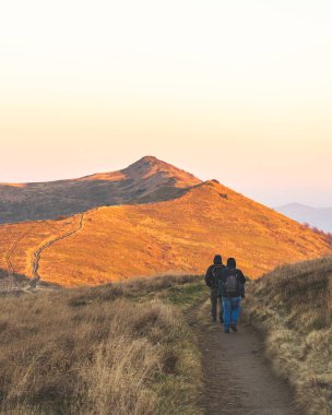 People hiking in Bieszczady mountains at autumn