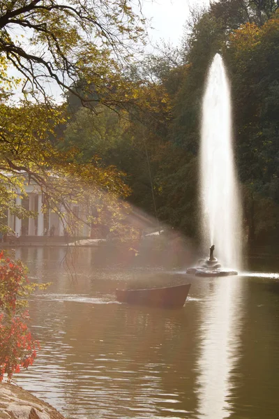 beautiful autumn landscape with a tree and a fountain