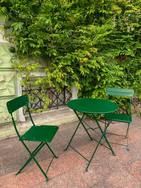 Balkonda yeşil sandalyeler