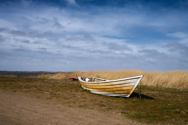 stock image old fishing boat on a lake shore