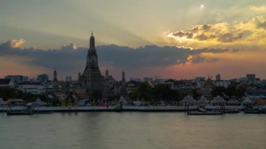 Wat Arun Ratchawararam Ratchawaramahawihan Buddhist Temple and Chao Phraya River in Bangkok Thailand Sunset Time Lapse