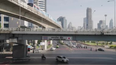 The Bangkok Mass Transit System BTS Skytrain Moving Between Buildings and Cityscape Thailand