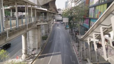 The Bangkok Mass Transit System BTS Skytrain Moving Between Buildings and Cityscape Thailand