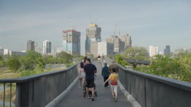 Man Running at Benjakitti Benchakitti Forest Park, Bangkok Thailand Skyline on Background Morning in Slow Motion