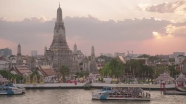 Wat Arun Ratchawararam Ratchawaramahawihan Buddhist Temple and Chao Phraya River in Sunset Crowd of Tourists Bangkok, Thailand