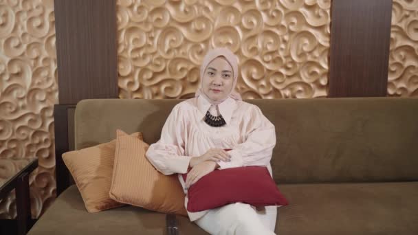 Modern Muslim Woman Hijab Southeast Asian Watching Using Remote While — Stockvideo