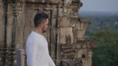 Travel Tourist Taking Photo of Angkor Wat from Phnom Bakheng Temple Sunset with Smartphone Slow Motion
