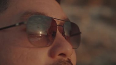 Man looking at Sun on the Beach Showing Hope, Optimism, Freedom, Happiness