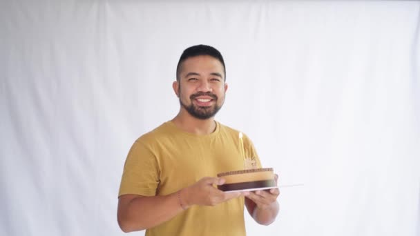 Male Model Blowing Candle Happy Birthday Cake White Background — Wideo stockowe