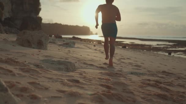 Homem Correndo Caminhando Praia Areia Descalço Durante Pôr Sol Slow — Vídeo de Stock