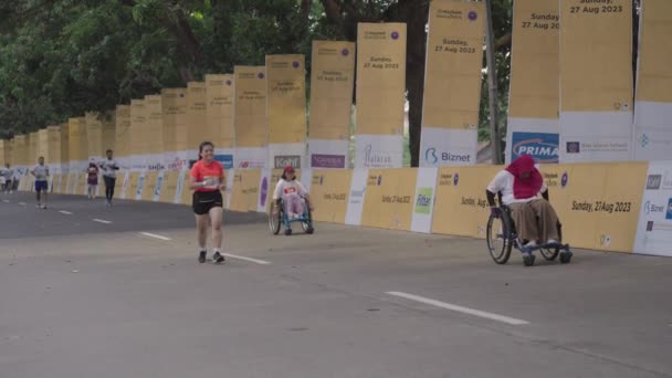 印度尼西亚巴厘 2023年8月27日 轮椅上的残疾人参加在吉亚尔举行的巴厘马拉松赛 — 图库视频影像