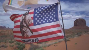 American Flag and Monument Valley, Towering Sandstone Buttes on Navajo Tribal on Arizona Utah Border USA