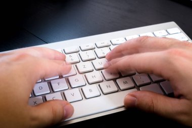 female hands typing on keyboard, close up 