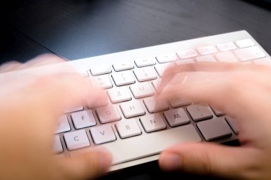 female hands typing on keyboard, close up 