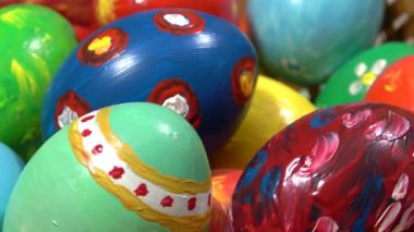 Mutlu Paskalyalar. Ev yapımı yumurta sepeti. Paskalya bayramı için renkli yumurtalarla dekoratif bir yuvanın yakınında daire şeklinde dönüyor.