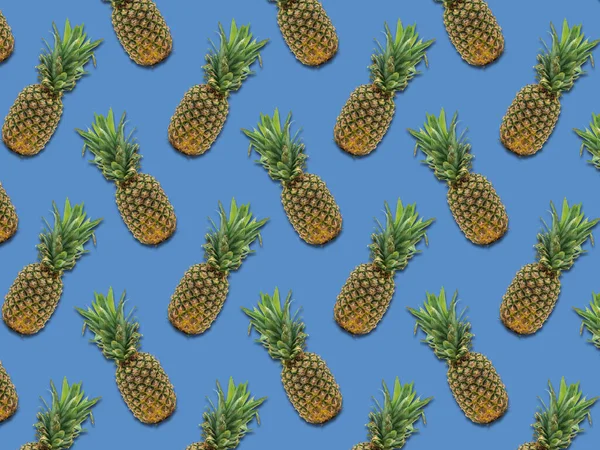 Pineapple fruits pattern on blue background. Colorful and delicious fruit for wallpapers