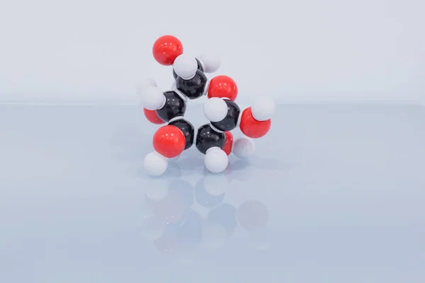 Isolated glucose molecule made by molecular model with reflection on blue background. C6H12O6 sugar chemical formula with colored atoms and bonds