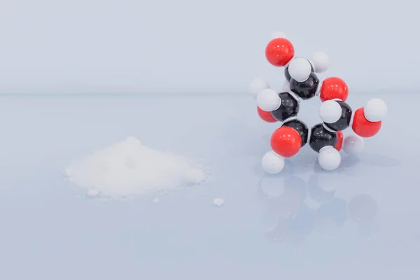 Isolated glucose molecule made by molecular model next to a little heap of white sugar. C6H12O6 sugar chemical formula with colored atoms and bonds