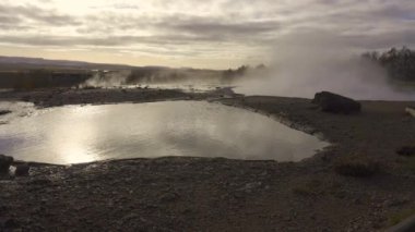 Geysir (The Great Geysir) geyser in southwestern Iceland. Geysir in Haukadalur valley on the slopes of Laugarfjall hill, which is also the home to Strokkur geyser.