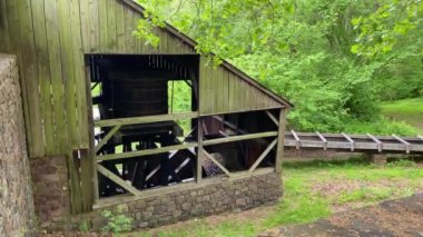 Hopewell Furnace National Historic Site in Pennsylvania. Hopewell's  waterwheel catches a flow of water from French Creek chase to power the furnace's air blast machinery.