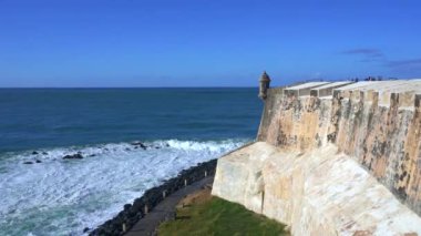 Fort wall sentry box above the Caribbean Sea crashing waves. Bartizan or garita at Castillo San Felipe del Morro, San Juan, Puerto Rico. Icon appears on Puerto Rican license plates and quarters. 