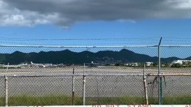 Maho Beach, Sint Maarten -2023: Beach by Princess Juliana International Airport, popular site for tourists and plane watchers. Arajet plane taking off.  Boeing 737 MAX 8. 