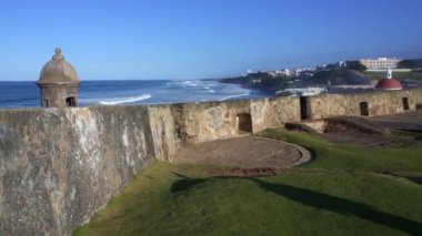 San Juan, Puerto. Esplanade and Caribbean at Castillo San Felipe del Morro, el Morro, San Juan National Historic Site. Bastin de San Antonio overlook the sea and Capilla del Cementerio Santa Mara.