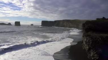 Dyrhlaey (Dyrholaey, Door Hill Adası, Cape Portland), İzlanda 'nın güney kıyısında, Vik yakınlarında yer alan küçük bir yerleşim yeri. Kirkjufjara Sahili deniz yığınları, kemer ve siyah kumsal manzarası. 