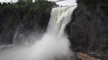 The Montmorency Falls (Chute Montmorency) large waterfall on Montmorency River where it drops into the Saint Lawrence River in Quebec, Canada. Protected within Montmorency Falls Park.