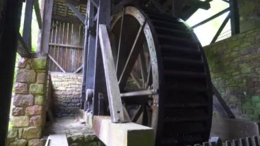 Hopewell Furnace National Historic Site in Pennsylvania. Hopewell's 22-foot diameter waterwheel catches a flow of water from French Creek to power the furnace's air blast machinery.