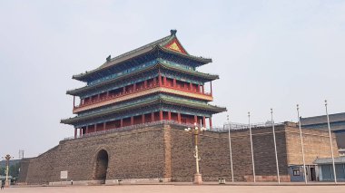 A panoramic view on a historic gatehouse Zhengyangmen, located on Tiananmen Square in Beijing, China. The construction consist of a high wall, and a house build on top of it. Defence building.