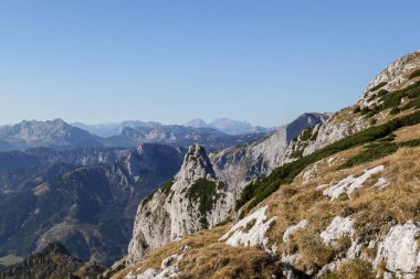 Panoramic view on mountains in Hochschwab region, Austrian Alps. The flora overgrowing slopes is golden. Autumn vibes in the mountains. Remote place, with no people. Freedom and wilderness