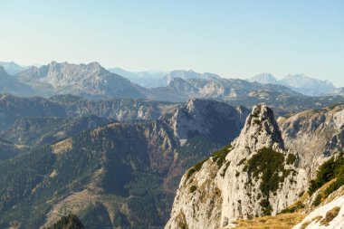 Panoramic view on mountains in Hochschwab region, Austrian Alps. The flora overgrowing slopes is golden. Autumn vibes in the mountains. Remote place, with no people. Freedom and wilderness