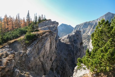 A very steep and narrow mountain ridge in Hochschwab region in Austrian Alps. Steep fall into the valley. Massive and dangerous Alps. Autumn vibes in the mountains. Freedom and wilderness