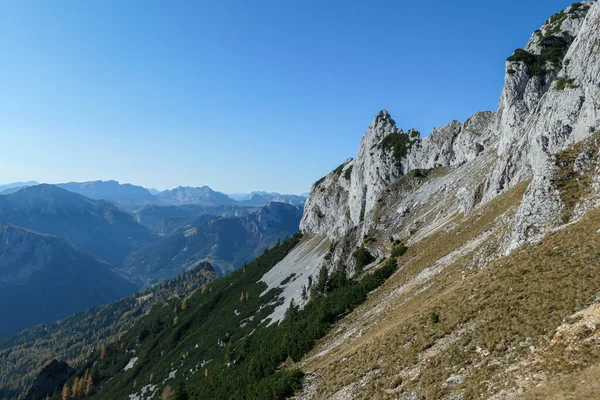 Panoramic view on mountains in Hochschwab region, Austrian Alps. The flora overgrowing slopes is golden. Autumn vibes in the mountains. Remote place, with no people. Freedom and wilderness