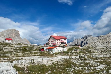 Sexten/Italy-09172020 A capture of the Tre Cime di Lavaredo cottage (Drei Zinnenhuette) in Italian Dolomites. The cottage has red decorative elements. There are high Alpine peaks around. Shelter
