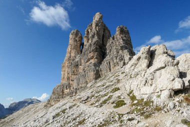 A panoramic view on Toblinger Knoten and surrounding mountains in Italian Dolomites. Difficult ad dangerous climbing route. Stony valley below. Few narrow pathways on the side. Freedom and serenity
