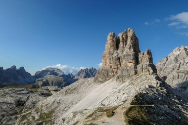 A panoramic view on Toblinger Knoten and surrounding mountains in Italian Dolomites. Difficult ad dangerous climbing route. Stony valley below. Few narrow pathways on the side. Freedom and serenity