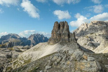 A panoramic view on Toblinger Knoten and surrounding mountains in Italian Dolomites. Difficult ad dangerous climbing route. Stony valley below. Few narrow pathways on the side. Freedom and serenity